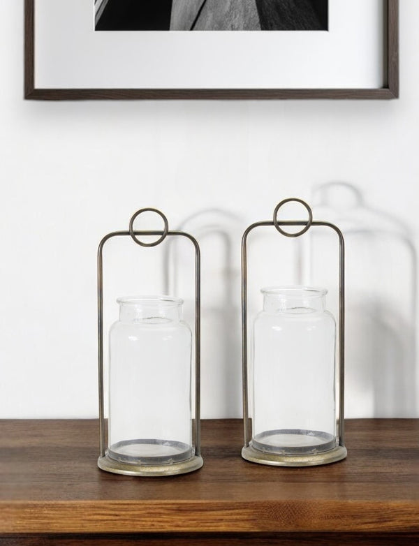 Homeroots Set Of Two Bronze Metal And Glass Tabletop Hurricane Candle Holders   517597