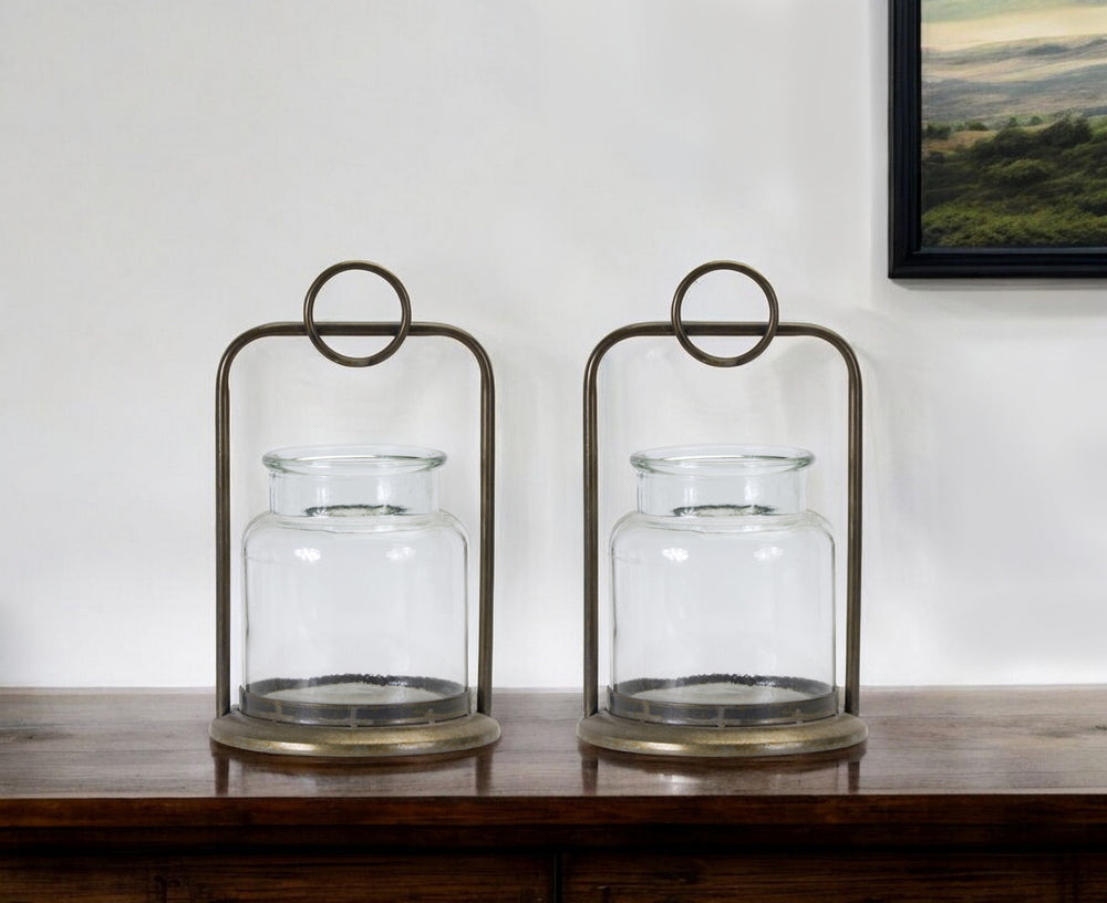 Homeroots Set Of Two Bronze Glass And Metal Tabletop Hurricane Candle Holders   517598