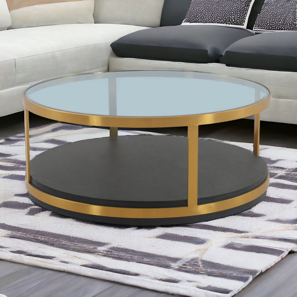 Homeroots 43" Clear And Black Gold Glass And Solid Wood And Metal Round Coffee Table With Shelf   520591