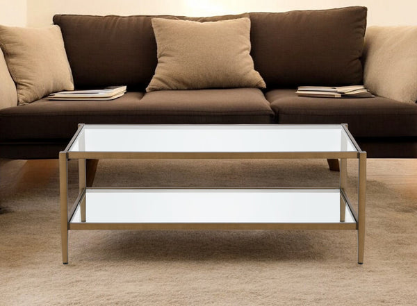 Homeroots 45" Clear And Antiqued Brass Glass And Metal Coffee Table With Shelf   521038