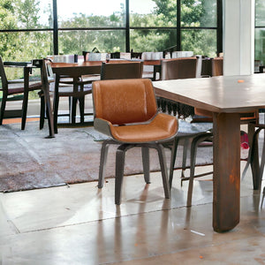 Homeroots Brown And Black Upholstered Faux Leather Curved Back Dining Side Chair  Wood 526378