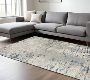 HomeRoots 9' Abstract Distressed Area Rug in Ivory, Gray, and Blue - Modern Artistry for Any Space 10' X 14' 527678