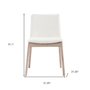HomeRoots Set of Two Stylish Upholstered Faux Leather Dining Chairs with Natural-Finish Legs for Versatility 527827