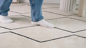 HomeRoots 5' Beige and Black Geometric Area Rug - Distressed Power Loom Design with Non-Skid Backing 8' X 11' 534405