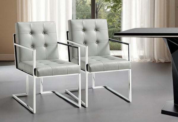 HomeRoots Set of Two Stylish Tufted Light Gray Faux Leather Dining Arm Chairs with Silver Accents & Comfort 543515