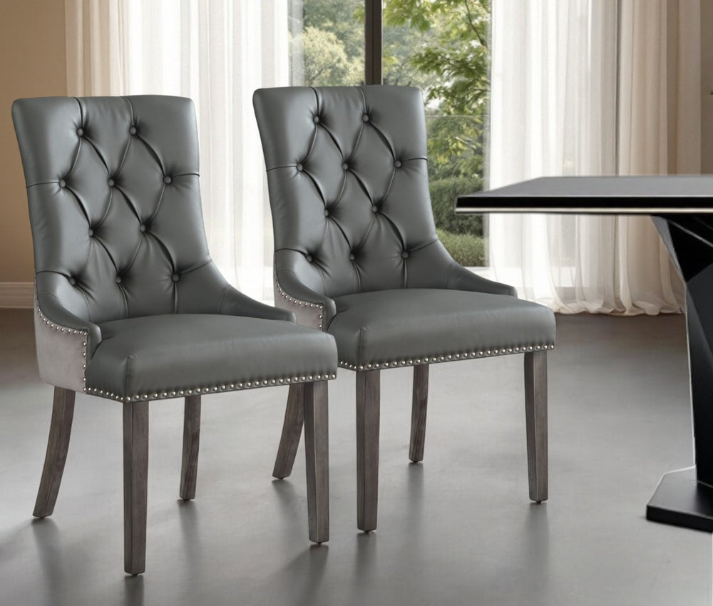 HomeRoots Set of Two Stylish Tufted Dark Gray & Black Faux Leather Dining Chairs for Versatile Spaces 543521