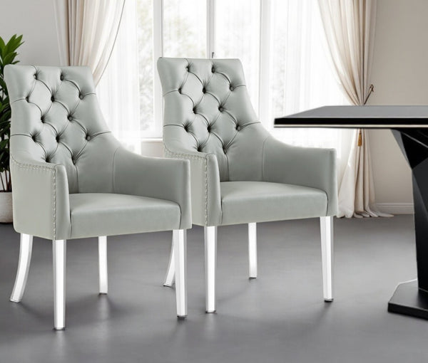 HomeRoots Set of Two Elegant Tufted Gray Faux Leather Dining Arm Chairs with Clear Legs for Versatile Seating 543544