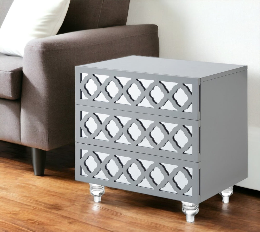 HomeRoots 24" Glamorous Mirrored Glass End Table with Geometric Cutwork and Three Drawers for Stylish Storage Light Grey 544097