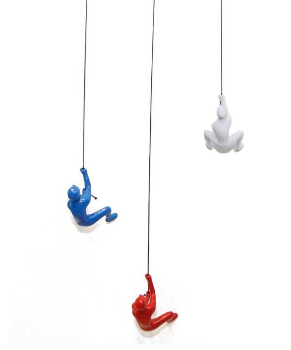 HomeRoots Set of Three Climbing Man Resin Sculptures - Whimsical 3D Wall Art in Blue, Red & White Finish 544459