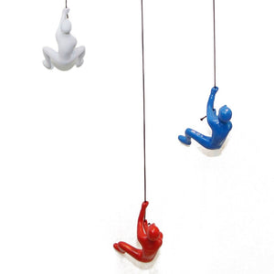 HomeRoots Set of Three Climbing Man Resin Sculptures - Whimsical 3D Wall Art in Blue, Red & White Finish 544459