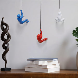 HomeRoots Set of Three Climbing Man Resin Sculptures - Whimsical 3D Wall Art in Blue, Red & White Finish 544459