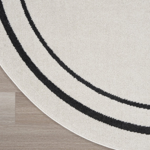 HomeRoots 8' Ivory and Black Round Rug - Weather-Resistant, Stylish Indoor & Outdoor Area Rug for Any Space 545534