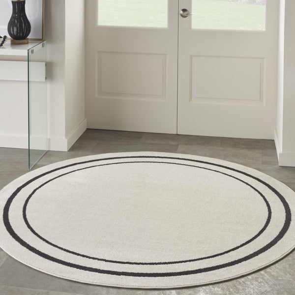HomeRoots 8' Ivory and Black Round Rug - Weather-Resistant, Stylish Indoor & Outdoor Area Rug for Any Space 545534