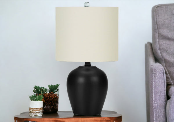 Homeroots 17" Black Ceramic Round Table Lamp With Ivory Drum Shade   545873
