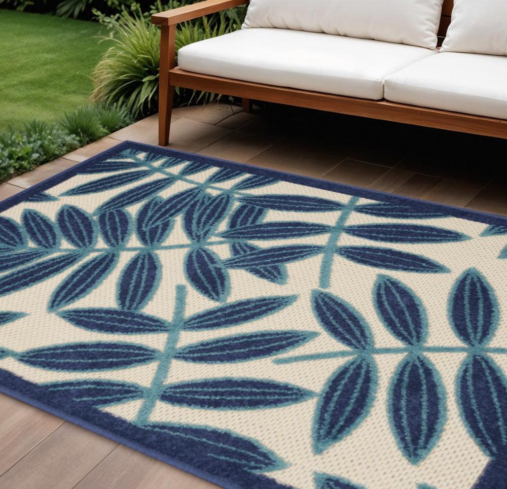 HomeRoots 5' Navy Blue and Beige Round Palm Leaf Rug - Durable Indoor Outdoor Area Rug for Coastal Charm 6' X 9' 546679