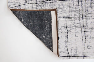 HomeRoots 9' X 13' Modern Black and White Abstract Area Rug with Non-Skid Backing for High-Traffic Spaces 548553