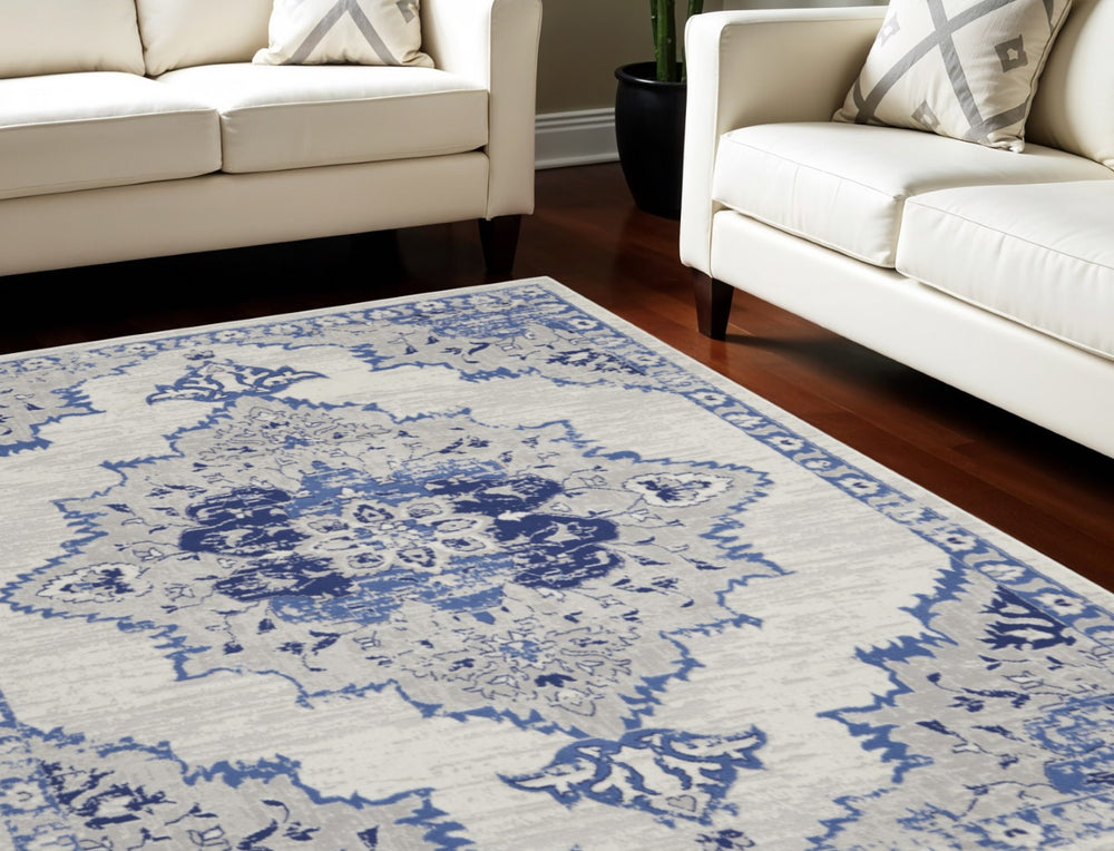 HomeRoots 7' Distressed Floral Medallion Area Rug in Ivory and Blue – Stain-Resistant, Non-Skid Comfort 7' X 10' 550625