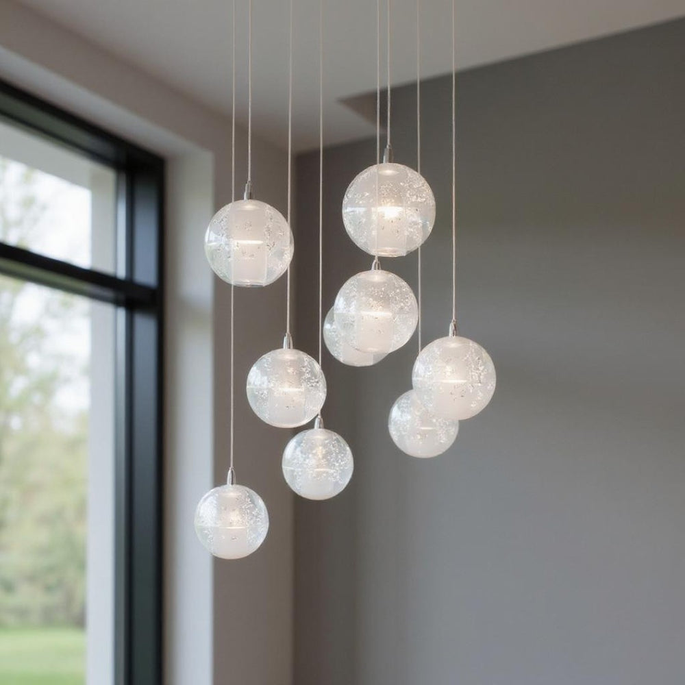 HomeRoots Silver Nine-Light Chandelier: Elegant Tiered Design with Clear Glass Shades for Modern Spaces 558710