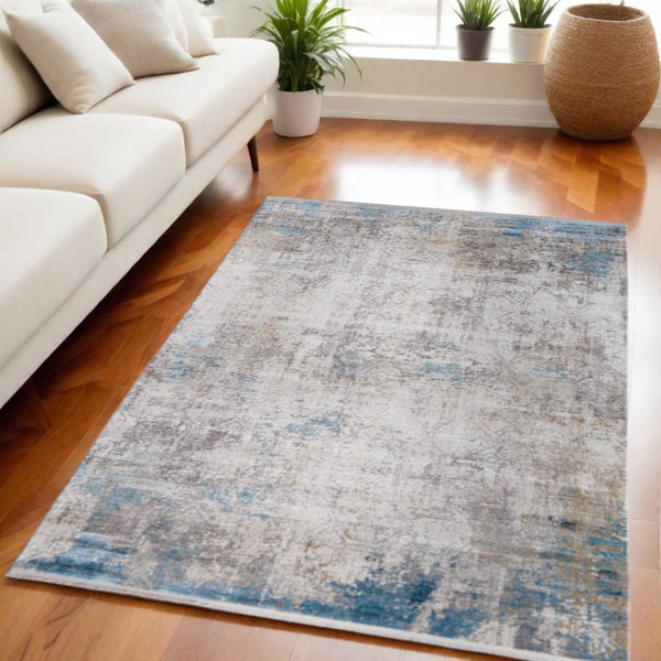 HomeRoots 3' Modern Abstract Ivory Gray and Blue Power Loom Area Rug with Tasseled Edges for Style & Comfort 5' X 8' 566013