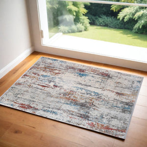 HomeRoots 3' Gray Blue and Red Abstract Power Loom Area Rug with Tassels - Elevate Your Space Instantly! 3' X 5' 566062