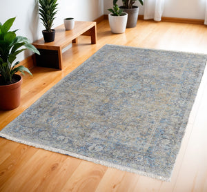 HomeRoots 4' Hand-Woven Distressed Area Rug in Gray Blue and Tan with Artistic Fringe for Modern Spaces 4' X 6' 566187