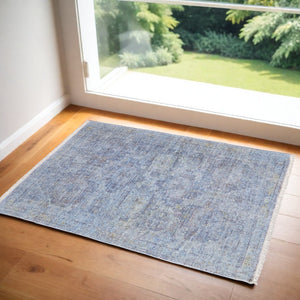HomeRoots 4' Blue and Ivory Abstract Hand-Woven Area Rug with Fringed Tassels – Unique Distressed Design 4' X 6' 566198