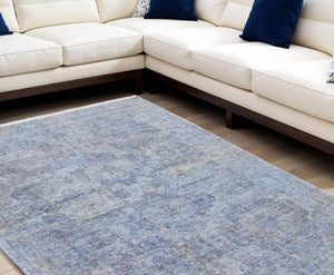 HomeRoots 4' Blue and Ivory Abstract Hand-Woven Area Rug with Fringed Tassels – Unique Distressed Design 8' X 10' 566200