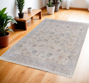 HomeRoots 4' Hand-Woven Distressed Floral Area Rug in Ivory Tan and Blue with Tasseled Fringe for Elegance 4' X 6' 566210