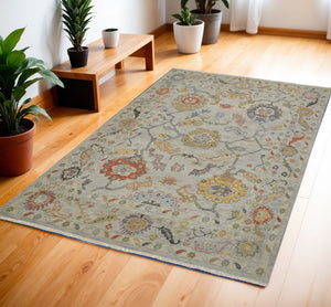 HomeRoots 4' Timeless Gray Red and Yellow Hand-Knotted Wool Oriental Rug with Fringe for Elegant Spaces 4' X 6' 566264