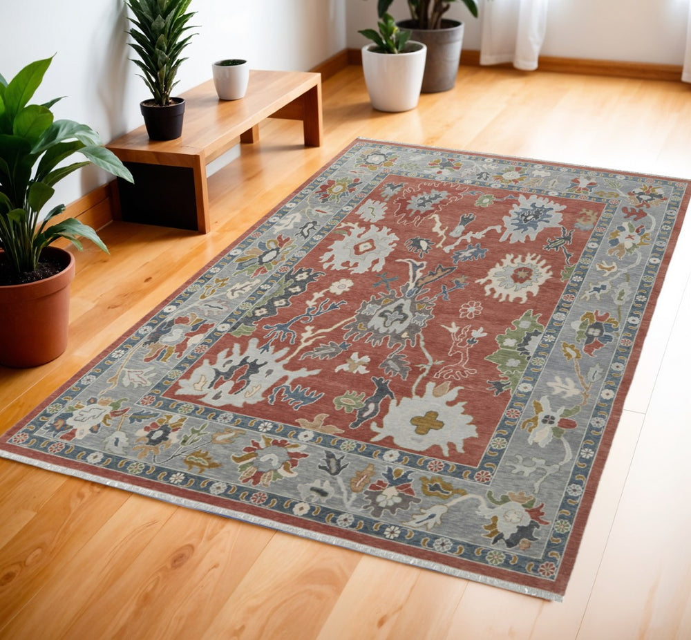 HomeRoots 4' Elegant Gray Red and Ivory Floral Wool Area Rug – Hand-Knotted Charm with Timeless Fringe 4' X 6' 566280