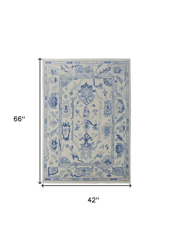 HomeRoots 4' Ivory and Blue Floral Hand-Knotted Wool Area Rug with Elegant Fringe for Timeless Home Style 4' X 6' 566298