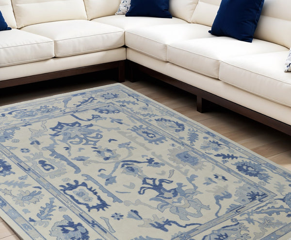 HomeRoots 4' Ivory and Blue Floral Hand-Knotted Wool Area Rug with Elegant Fringe for Timeless Home Style 6' X 9' 566299