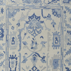 HomeRoots 4' Ivory and Blue Floral Hand-Knotted Wool Area Rug with Elegant Fringe for Timeless Home Style 6' X 9' 566299