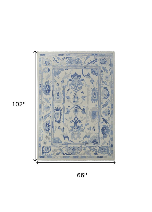 HomeRoots 4' Ivory and Blue Floral Hand-Knotted Wool Area Rug with Elegant Fringe for Timeless Home Style 6' X 9' 566299