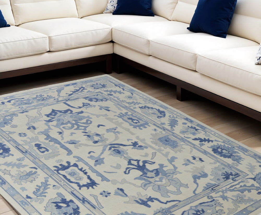 HomeRoots 4' Ivory and Blue Floral Hand-Knotted Wool Area Rug with Elegant Fringe for Timeless Home Style 8' X 10' 566300