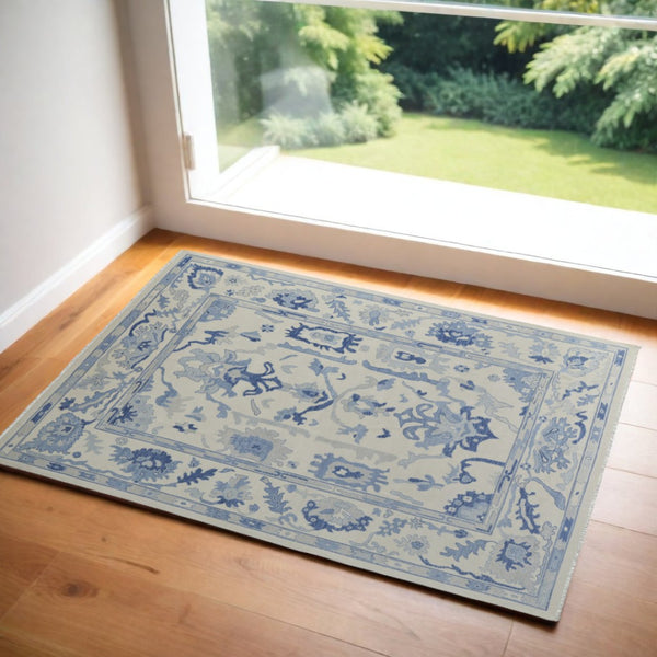 HomeRoots 4' Ivory and Blue Floral Hand-Knotted Wool Area Rug with Elegant Fringe for Timeless Home Style 2' X 3' 566303