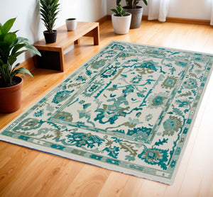 HomeRoots 4' Ivory and Blue Floral Hand-Knotted Wool Area Rug with Elegant Fringe for Timeless Home Style 4' X 6' 566304