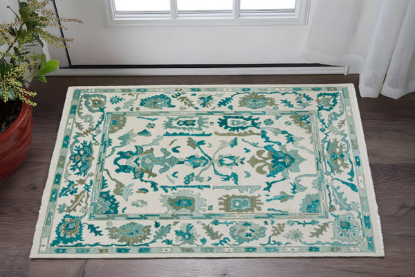 HomeRoots 4' Ivory and Blue Floral Hand-Knotted Wool Area Rug with Elegant Fringe for Timeless Home Style 2' X 3' 566309