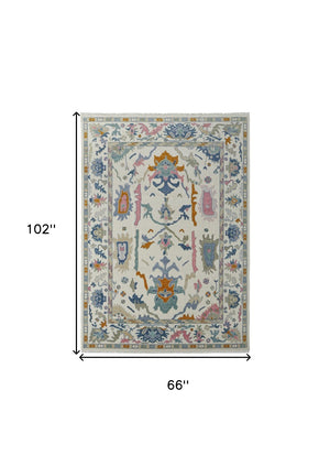 HomeRoots 4' Hand-Knotted Floral Wool Area Rug in Blue, Ivory & Pink - Durable, Stain-Resistant Design 6' X 9' 566311