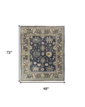 HomeRoots 3' Hand-Knotted Blue and Gray Floral Wool Area Rug with Fringe - Timeless Charm for Any Room 4' X 6' 567096