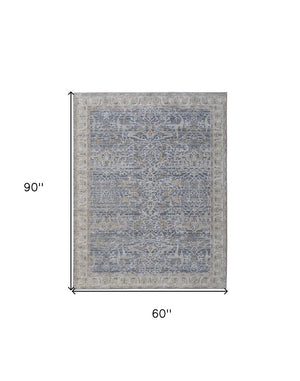 HomeRoots 5' Blue Taupe and Ivory Ikat Distressed Area Rug with Fringed Tassels for Chic Home Decor Style 5' X 8' 567556