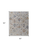 Homeroots 5' X 8' Ivory Blue And Gold Floral Power Loom Worn Faded Area Rug With Fringe Ivory Polyester 567595