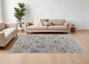 Homeroots 8' X 10' Ivory Blue And Gold Floral Power Loom Worn Faded Area Rug With Fringe Ivory Polyester 567597