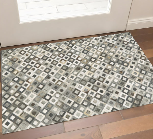 HomeRoots 2' Black Gray and White Faux Cowhide Geometric Area Rug - Modern Rustic Charm for Any Space 2' X 3' 567700