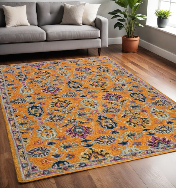 HomeRoots 5' Vibrant Floral Hand-Tufted Wool Area Rug - Artisanal Orange, Purple & Blue Design for Cozy Spaces 5' X 8' 570703