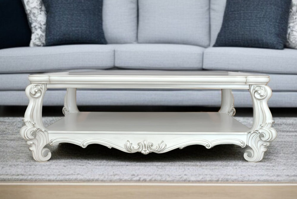 Homeroots 57" White Wood Ornate Coffee Table With Shelf - Chic Design For Stylish Storage & Home Decor!   572270
