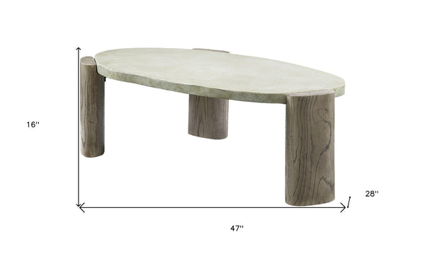 HomeRoots 47" Rustic Oval Cement Coffee Table with Distressed Beige Top & Warm Oak Legs for Modern Living Spaces 572275