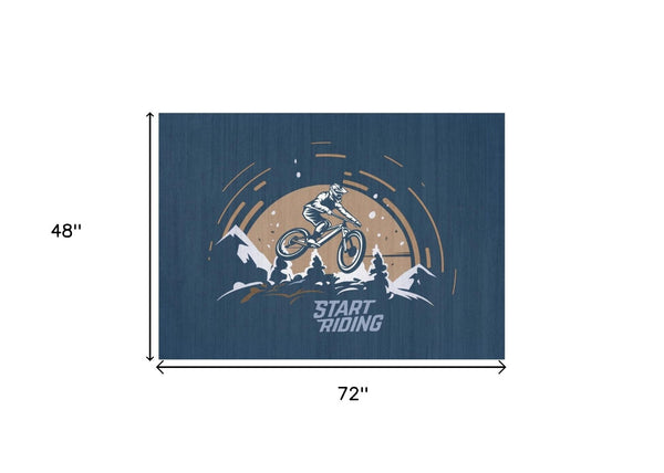 HomeRoots 5' Mountain Biker Area Rug – Vibrant Blue, Gold & White Design for Kids' Rooms, Easy Care & Durable 7' X 9' 573709