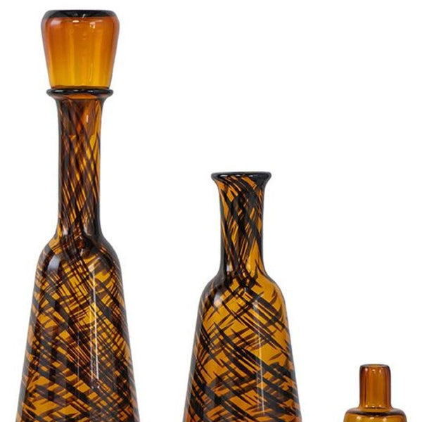 HomeRoots Set of Three Amber Swirl Glass Bottles with Stoppers – Stylish Decor for Any Space, Gift-Ready! 574229
