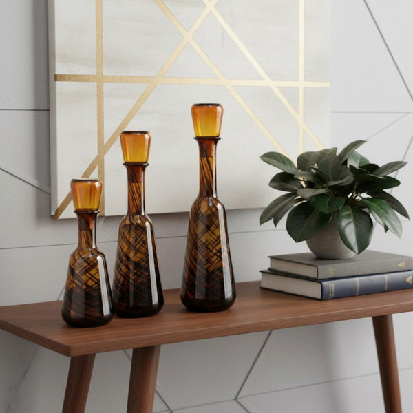 HomeRoots Set of Three Amber Swirl Glass Bottles with Stoppers – Stylish Decor for Any Space, Gift-Ready! 574229